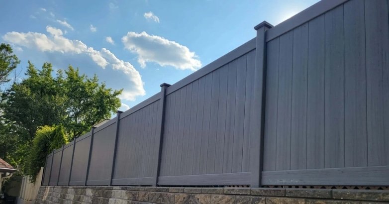 A sleek gray vinyl fence panel, highlighting contemporary fencing styles in the five boroughs.