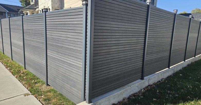 A stylish fence made of wood and metal, representing modern privacy fencing trends in urban settings.