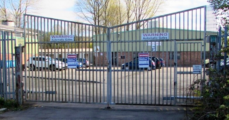 A gate marked with a "danger" sign, highlighting the importance of security and privacy in automated business environments.