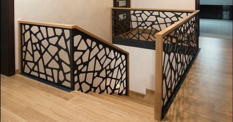 Artistic black stairway featuring laser-cut railings in a New York interior setting.