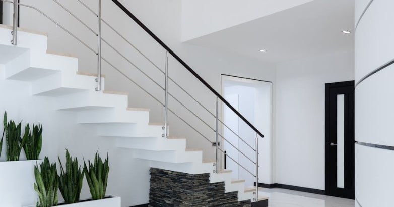 Contemporary staircase with white walls and black railings, reflecting an industrial chic style in a New York interior.