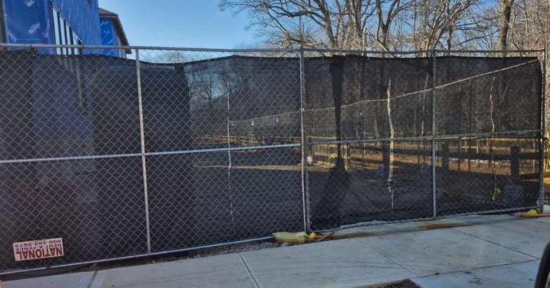 Five Boroughs Fencing Solutions builds a chain-link fence around a tennis court, enhancing security and property boundaries.