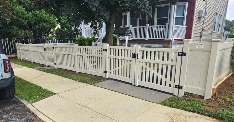 A wooden fence with a gate and a parked car in front, showcasing an outdoor aesthetic for property enhancement.