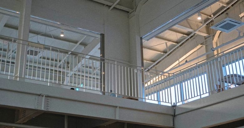  Interior view of a building featuring a balcony with decorative railings, highlighting the design of interior railings.