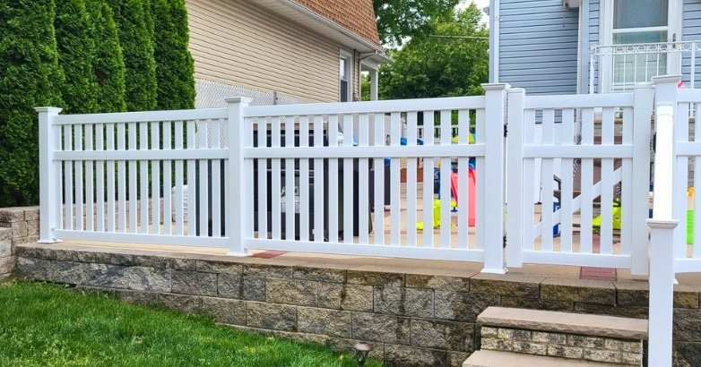 White vinyl railings on a backyard patio, durable railing materials for coastal homes in the Tri-State Area.
