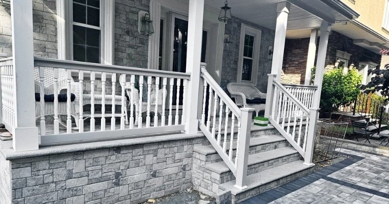 Why Every Home with a Deck Needs Quality Railings Boosts Your Home’s Curb Appeal A white porch featuring a white railing and steps, enhancing the home's curb appeal and inviting outdoor enjoyment.