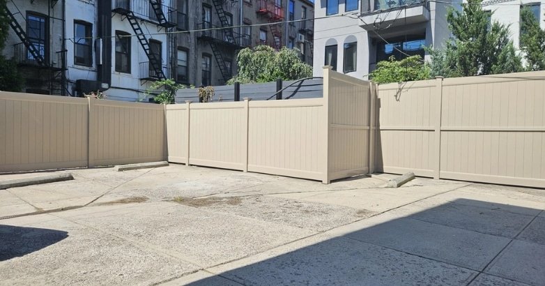 How to Choose the Right Fencing Contractor In The Metro Area Local Knowledge Wins A fence is positioned in the center of a street, emphasizing the need for careful selection of a fencing contractor in the metro area.