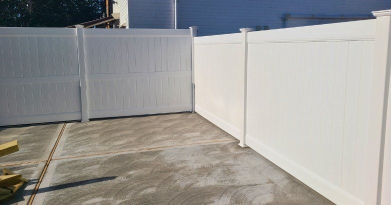 Checklist for Planning a Fencing Project Vinyl Fence A white vinyl fence is being installed in a backyard, illustrating steps from a fencing project planning checklist.