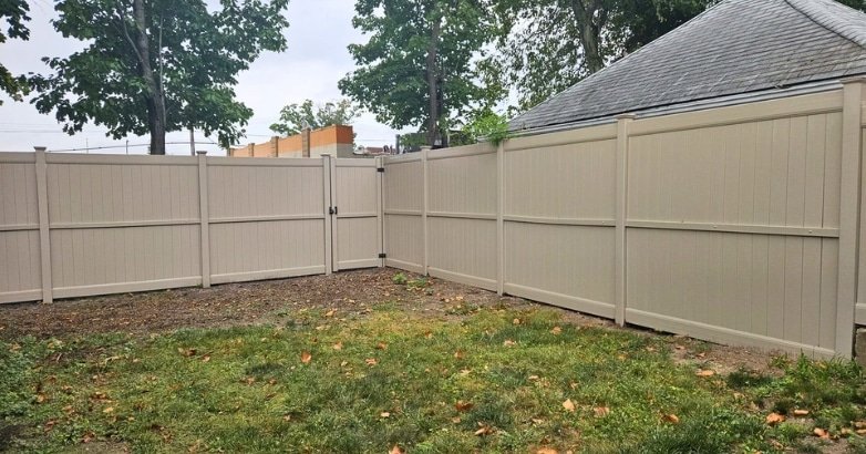 Upgrading Your Old Fence Choosing the Right Material A fence is under construction in a backyard, emphasizing the theme of upgrading to suitable fencing materials.