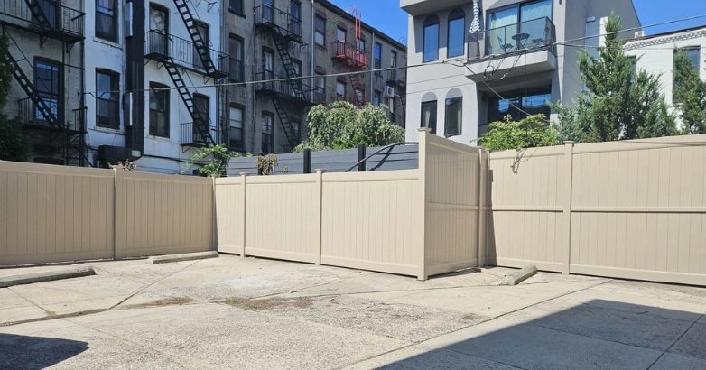 Fencing Solutions for High Traffic Urban Areas Why Professional Installation Is Critical A fence obstructs a street, emphasizing the importance of expert installation for high-traffic urban environments.